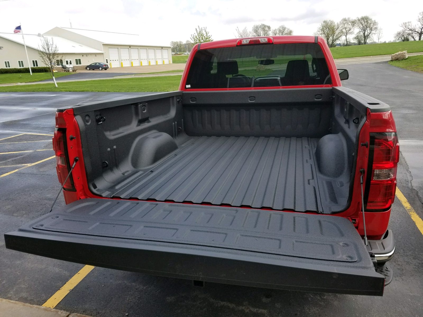 Pickup truck with a sprayed-on textured black polyurea bed liner covering the bed floor, walls and tailgate