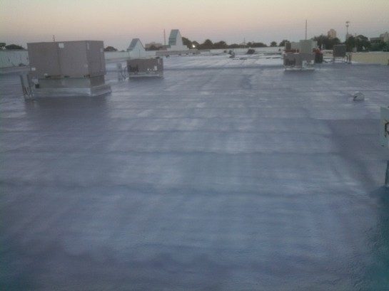Closed-cell spray polyurethane foam applied as a roofing substrate before a protective top coat