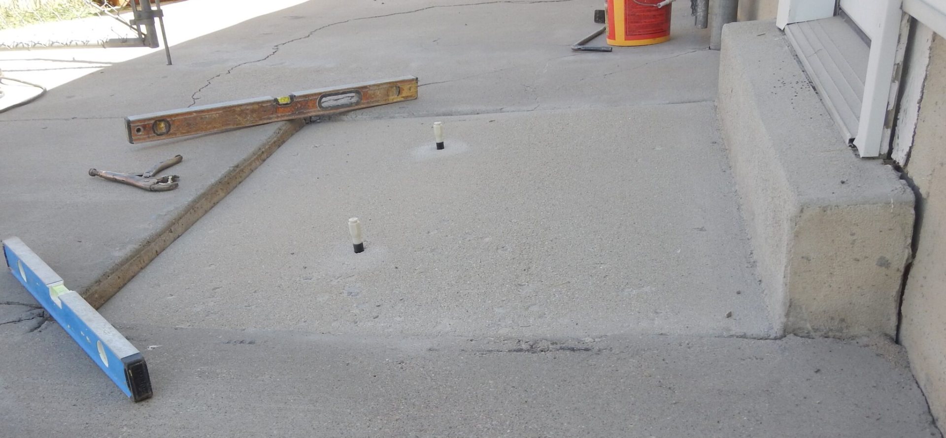 Uneven concrete slab with visible drop before poly lifting repair