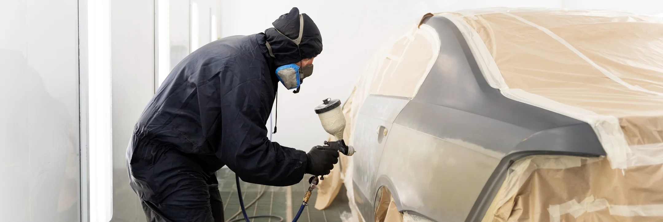 Professional contractor applying Flak Jacket polyurea bed liner with spray equipment